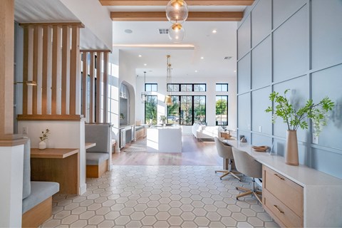 a dining room with a long table and chairs and a large open room with windows