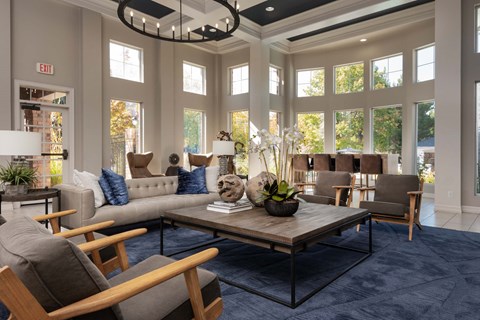 a living room with couches and chairs and a table