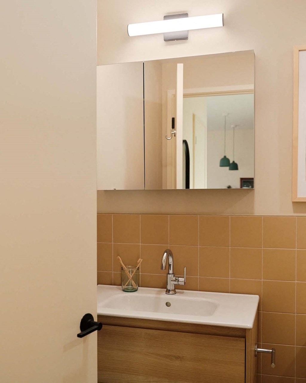 a small bathroom with a sink and a mirror