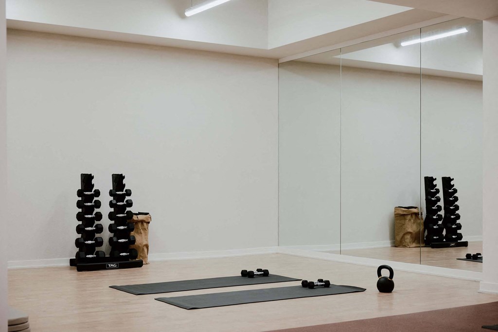 a yoga room with mirrors and yoga mats on the floor