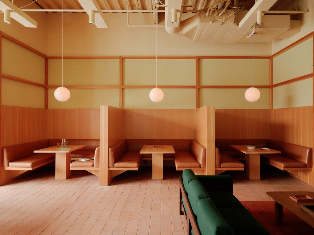 a restaurant with wooden booths and tables and benches