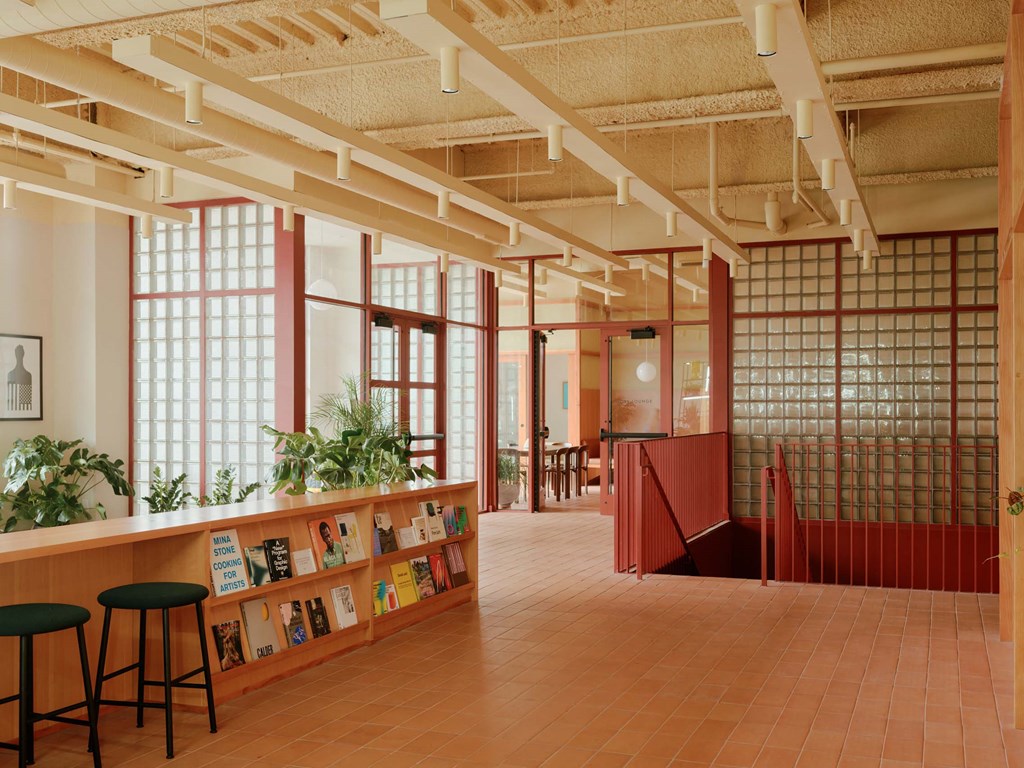 the lobby of a library with a counter and stools