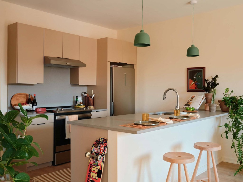 a kitchen with a counter and some bar stools