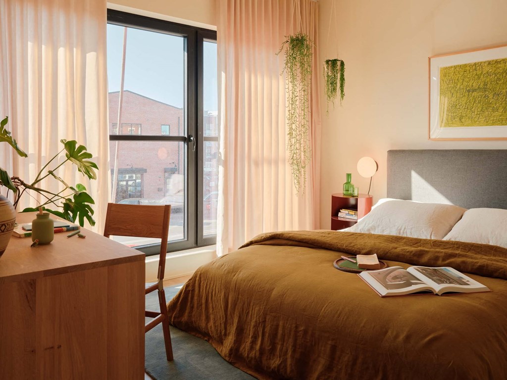 a bedroom with a bed and a window