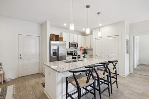 A kitchen with a white countertop and a refrigerator.