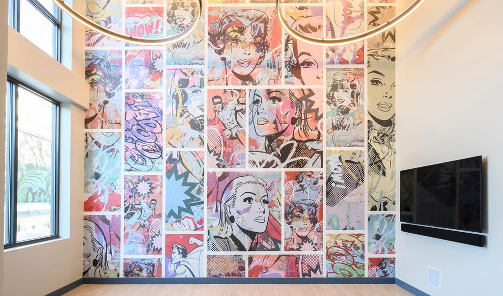 a large mural on the wall of a room with a television