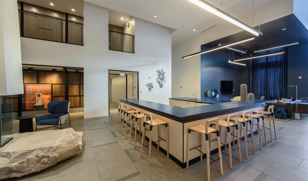 a long bar with high chairs in a lobby