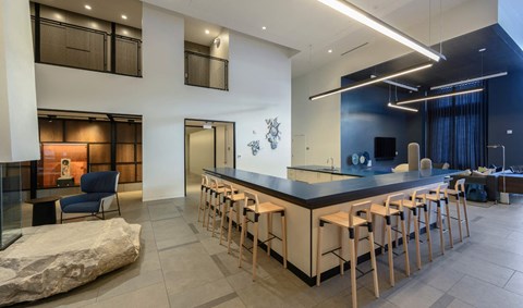 a long bar with high chairs in a lobby