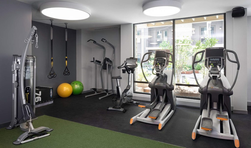 a gym with exercise equipment and a window