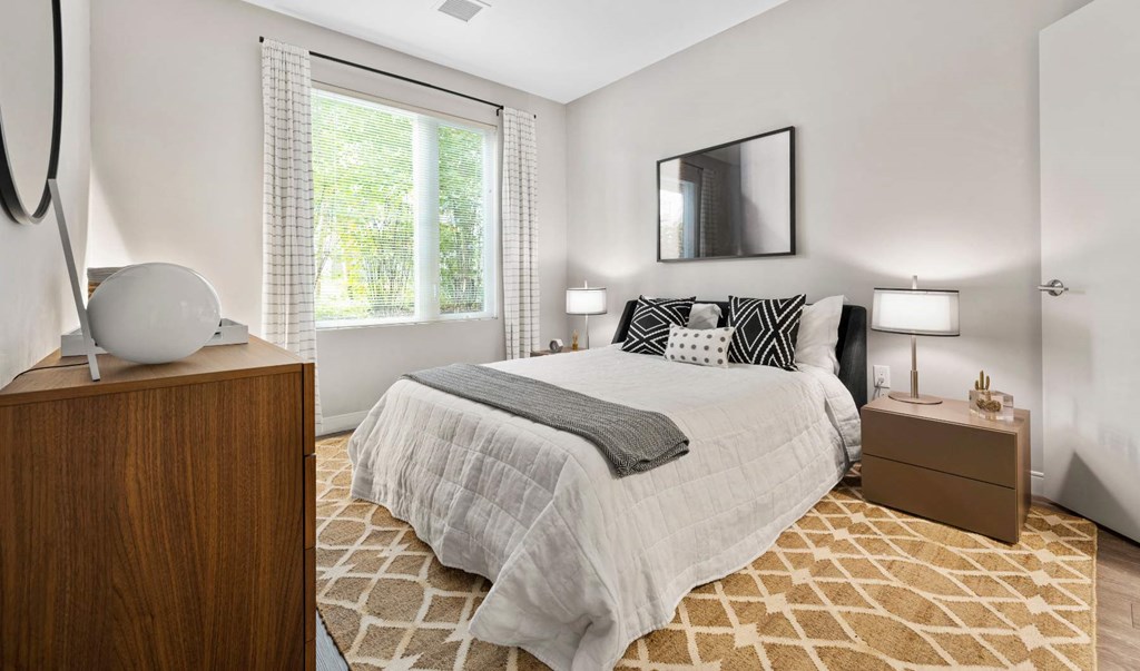 a bedroom with a bed and three windows