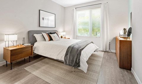 a bedroom with a bed and a window