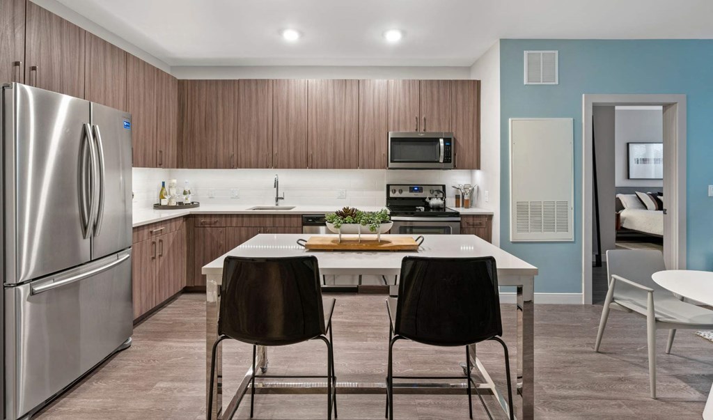 a kitchen with stainless steel appliances and a white table