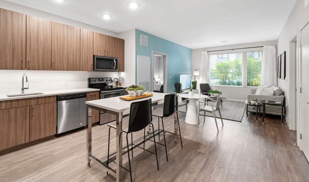 a kitchen and living room with a table and chairs