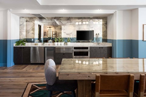 A modern kitchen with a wooden table and chairs.