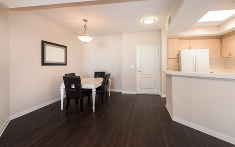 A dining room with a table and chairs.