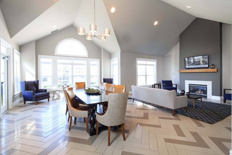 a dining room and living room with a table and chairs