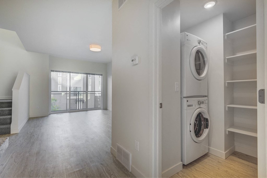 a laundry room with a washer and dryer and a window