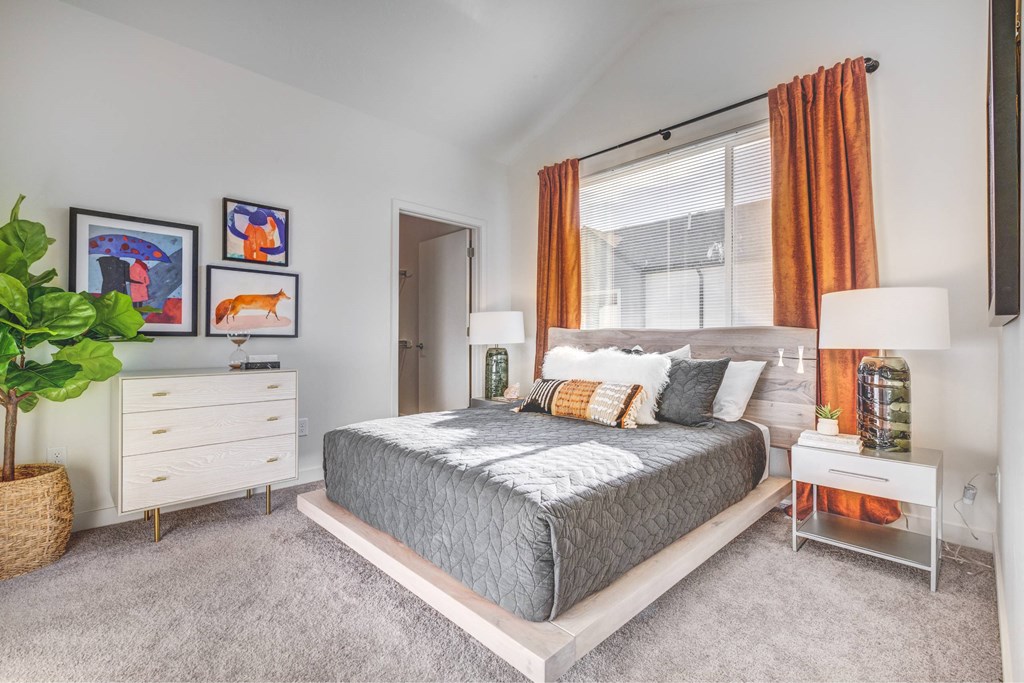 a bedroom with a bed and a large window