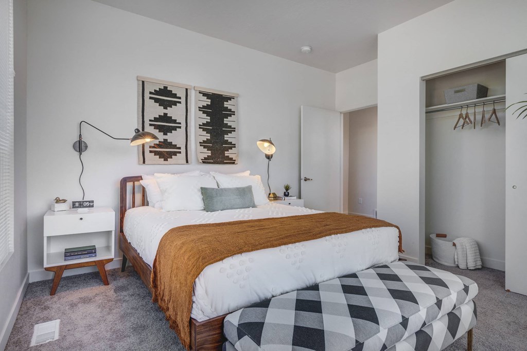 a bedroom with a bed and a black and white checkered bedspread
