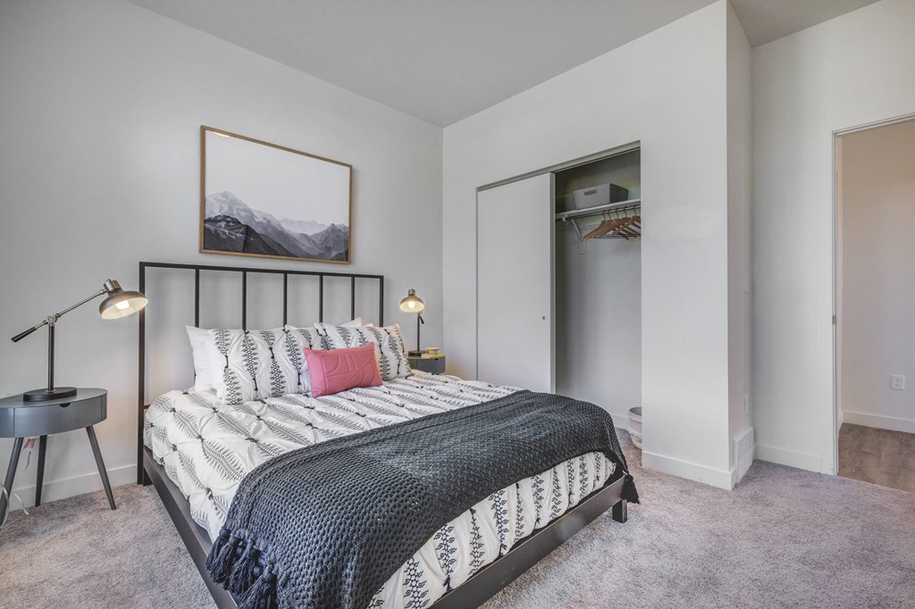 a bedroom with a bed and a mirror