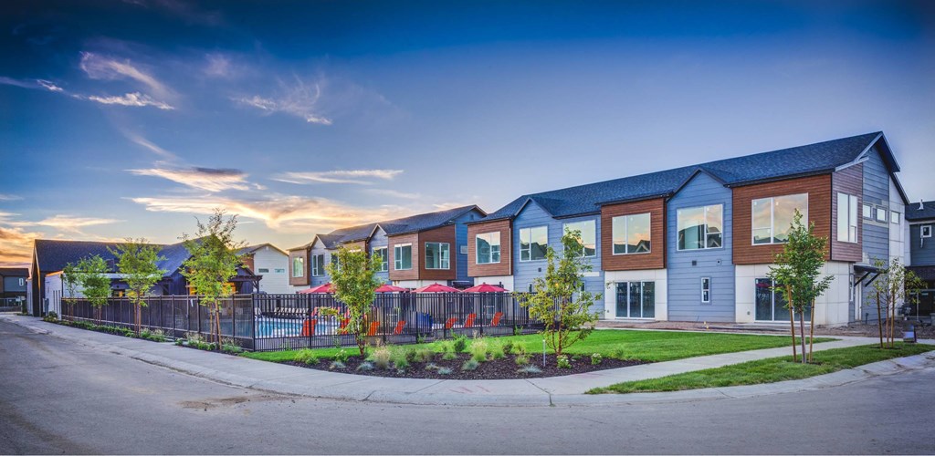 a row of houses with a street in front of them