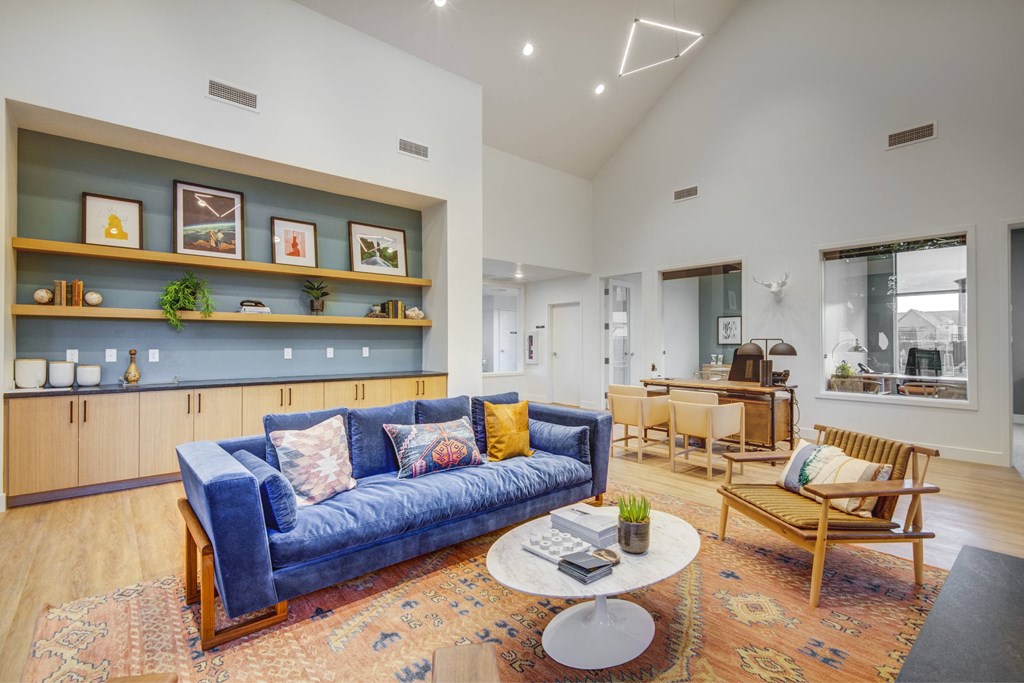 a living room with a blue couch and a coffee table