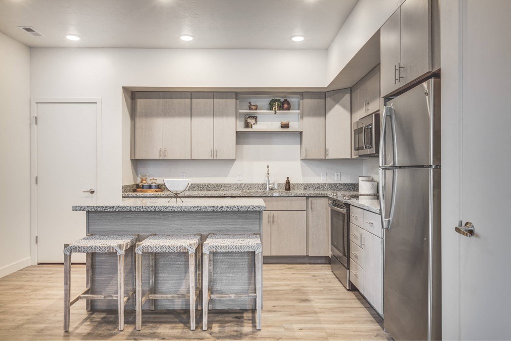 a kitchen with a island and three stools