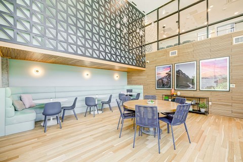 A modern dining area with a wooden table and chairs.