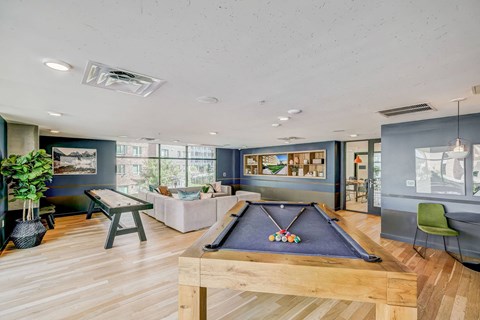 a game room with a pool table and a couch