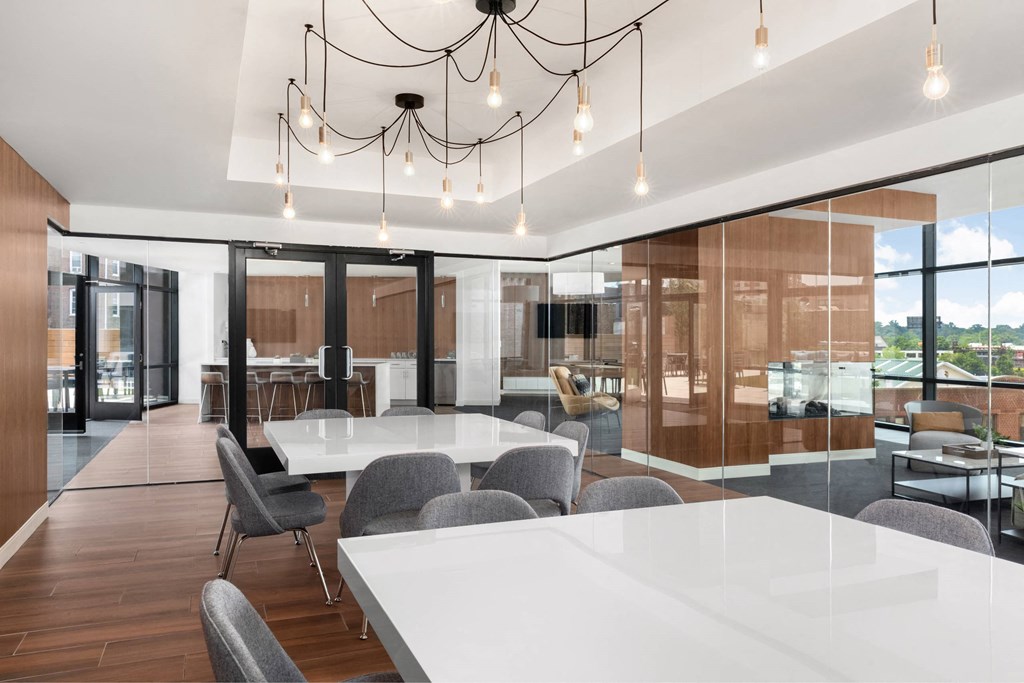 a large conference room with white tables and chairs
