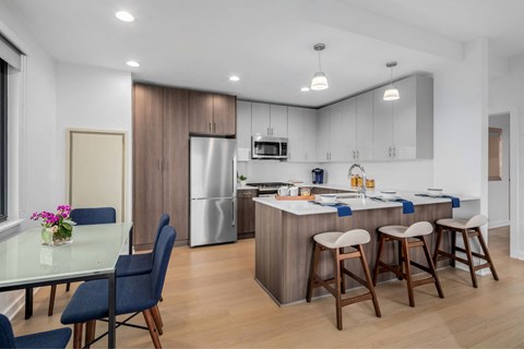 A modern kitchen with a dining table and chairs.