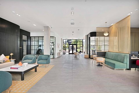 A modern living room with a long wooden bench and a grey couch.