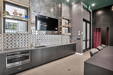 A modern kitchen with a checkered backsplash and a large island.