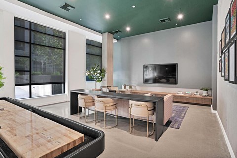 A modern living room with a flat screen TV mounted on the wall.