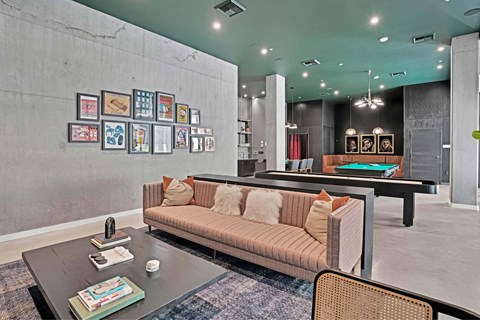 A living room with a couch, coffee table, and pictures on the wall.