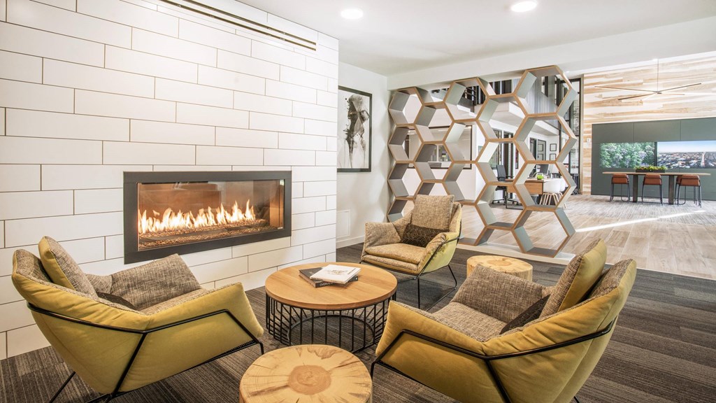 A modern living room with a fireplace and a large abstract art piece on the wall.at Axle, Seattle Washington