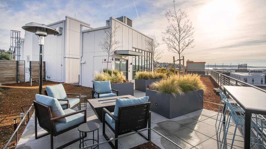 A patio with a table and chairs overlooking a body of water.at Axle, Seattle, WA