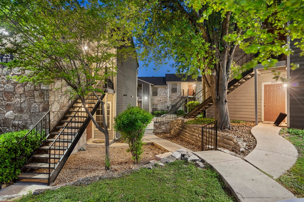 A residential area with a house, a tree, and a staircase.