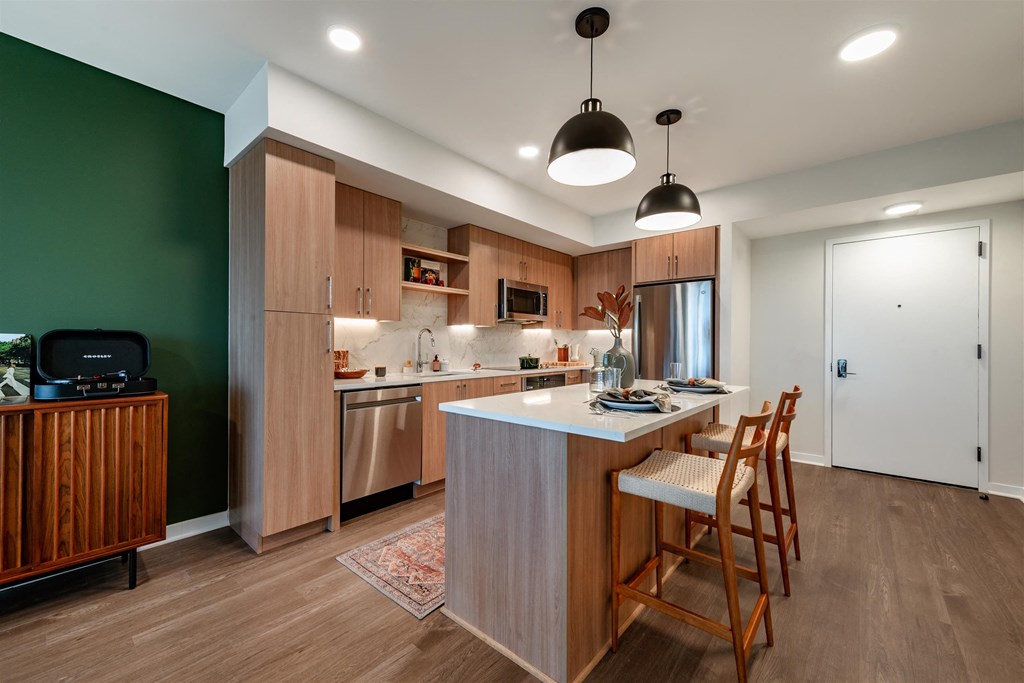 A modern kitchen with wooden cabinets and a central island.