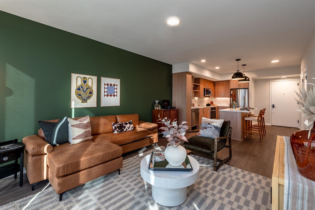 A living room with a brown couch and a white coffee table.