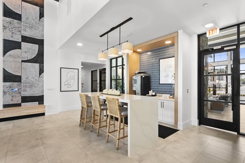 A modern kitchen with a dining table and chairs.