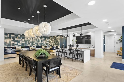 A modern dining room with a large table and chairs.