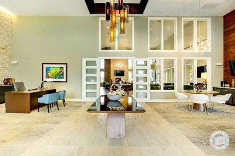 A modern living room with a wooden floor and a large painting on the wall.