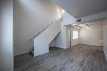 A room with a staircase and a window.