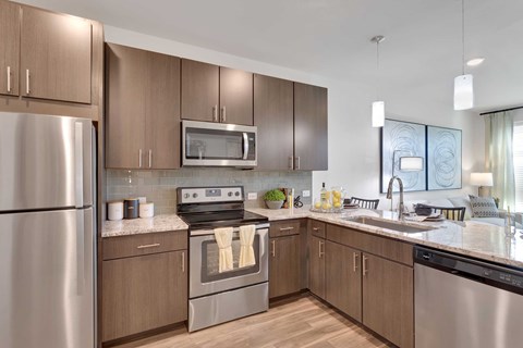 A modern kitchen with wooden cabinets and stainless steel appliances.