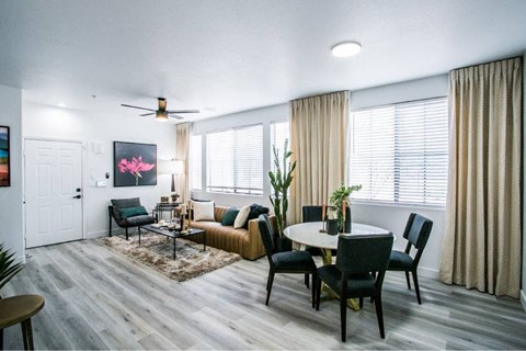 A living room with a dining table and chairs.
