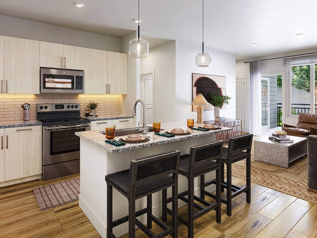 A kitchen with a bar area and chairs.