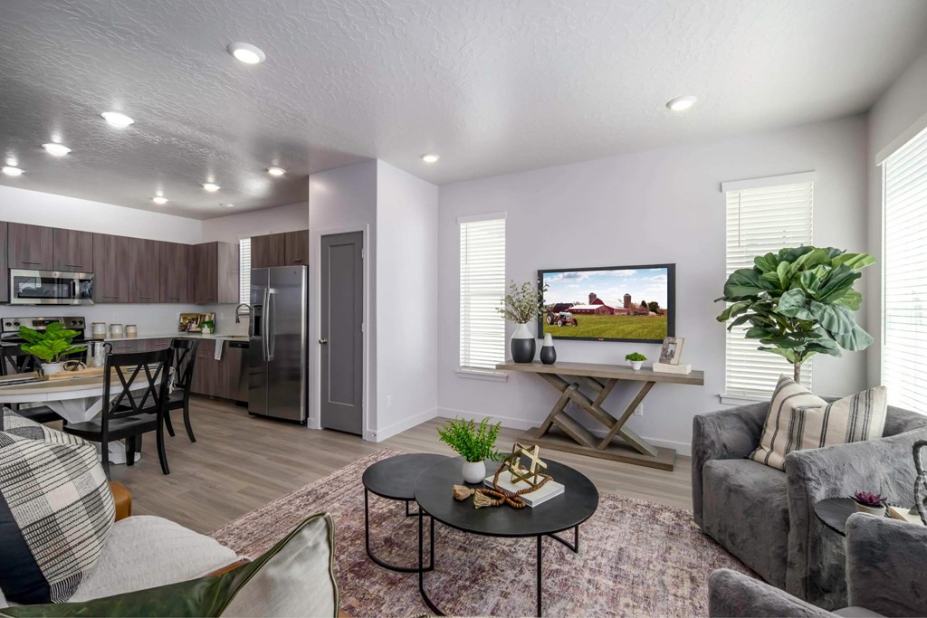 Living room with a grey couch at Rise new townhomes in Utah