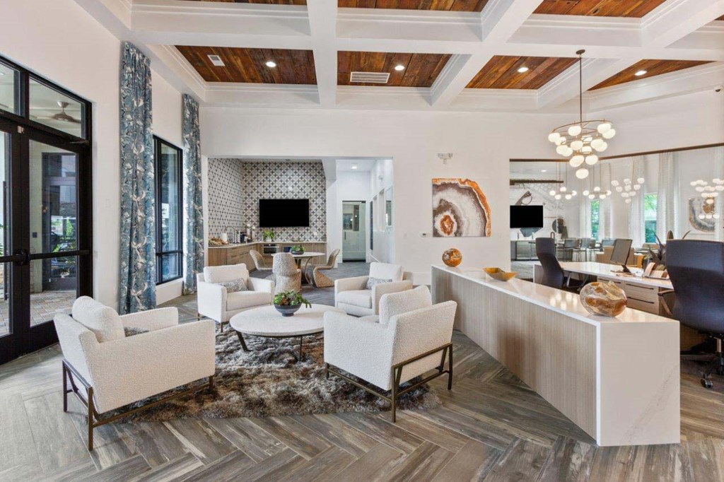 A modern living room with a white sofa set and a wooden coffee table.