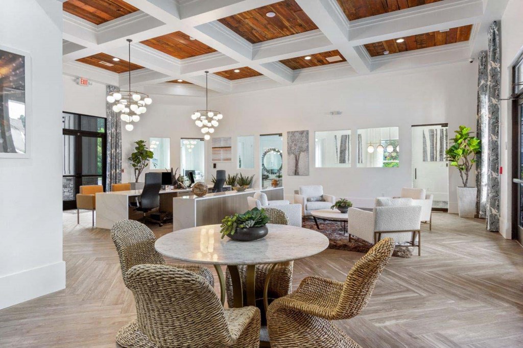 A large room with a round table and chairs.